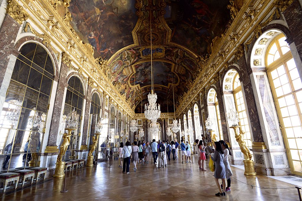 People visit the Hall of Mirrors ("Galerie des glaces") of the Chateau de Versailles on June 24, 2014, in Versailles, France. Courtesy of BERTRAND GUAY/AFP/Getty Images.