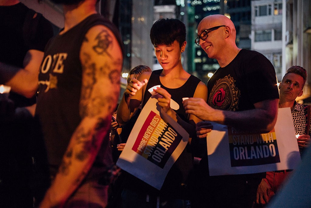 eople gather during a vigil for the victims of a shooting in a gay nightclub in Orlando, Florida on June 13, 2016 in Hong Kong, Hong Kong. The vigil is put together by Betty Grisoni co-director of Pink Dot and co-founder of local lesbian group Les Peches with Double Happiness, Les Peches, Out in HK and Pink Alliance joining in as supporting organisations. Photo by Anthony Kwan/Getty Images.