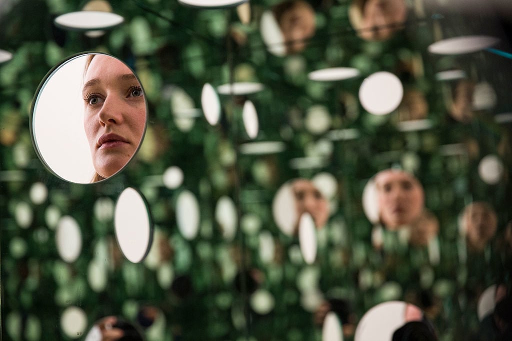 A Tate employee views The Passing Winter 2005 by Japanese artist Yayoi Kusama, in the new Switch House extension of the Tate Modern, in London on June 14, 2014. Courtesy of Daniel Leal-Olivas/AFP/Getty Images.