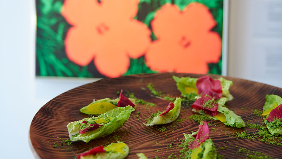 Canapes, prepared by Ollie Dabbous for Sotheby's London ahead of their February contemporary sale, in front of Andy Warhol's Flowers. Courtesy of Sotheby's London.