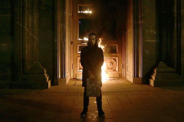 Russian artist Pyotr Pavlensky poses after setting fire to the doors of the headquarters of the FSB security service, the successor to the KGB, in central Moscow early on November 9, 2015. Courtesy of Nigina Beroeva/AFP/Getty Images.