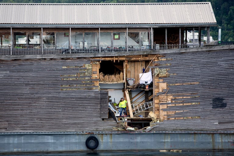 A crew member inspects damages on the hull of a full-size replica of the Ark of Noah after it crashed into a moored coast guard vessel in Oslo harbor on June 10, 2016. Courtesy of photographer Hakon Mosvold Larsen/AFP/Getty Images.