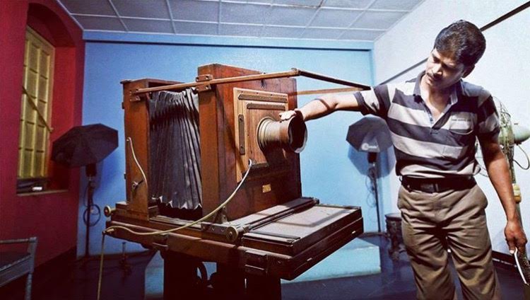 File Photo-A man cleaning the old cameras at one of the world’s oldest photo studio ‘Bourne and Shepherd’ which closed the shop after 176 years in Kolkata on Sunday. PTI PhotoPhoto: @deccanherald_official Instagram