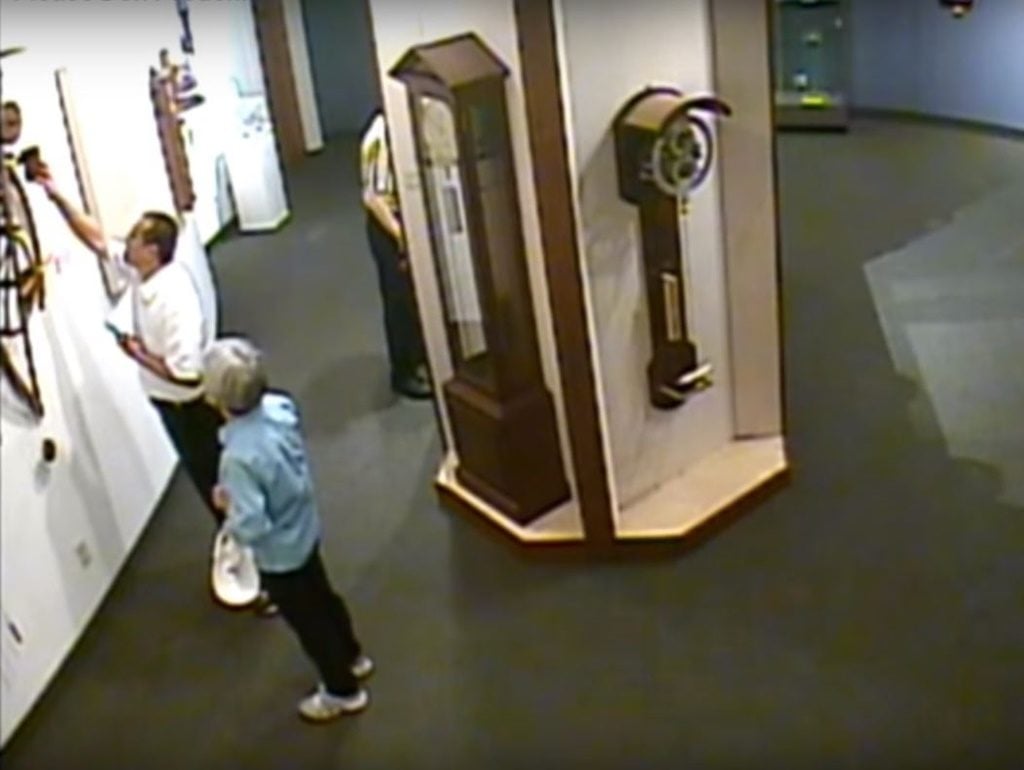A visitor to the National Clock & Watch Museum brutally mistreats a clock by James Borden. Photo via YouTube.