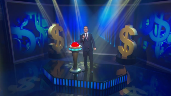 John Oliver forgives a mountain of debt with the push of a button. Courtesy of YouTube.com.