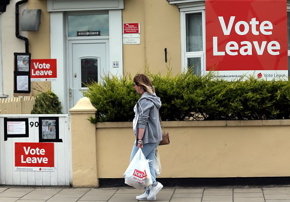 A woman walks past a house where "Vote Leave" boards are displayed in Redcar, north east England on June 27, 2016 Britain's historic decision to leave the 28-nation bloc has sent shockwaves through the political and economic fabric of the nation. It has also fuelled fears of a break-up of the United Kingdom with Scotland eyeing a new independence poll, and created turmoil in the opposition Labour party where leader Jeremy Corbyn is battling an all-out revolt. / AFP / Scott Heppell (Photo credit should read SCOTT HEPPELL/AFP/Getty Images)