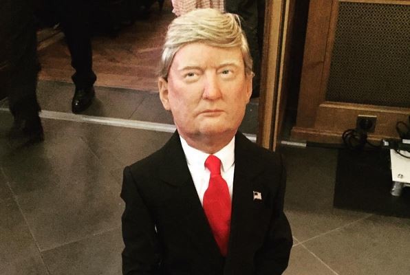 A sculpture of a kneeling Donald Trump at Basel's hotel Les Trois Rois. Photo via Emily Santangelo, on Instagram.