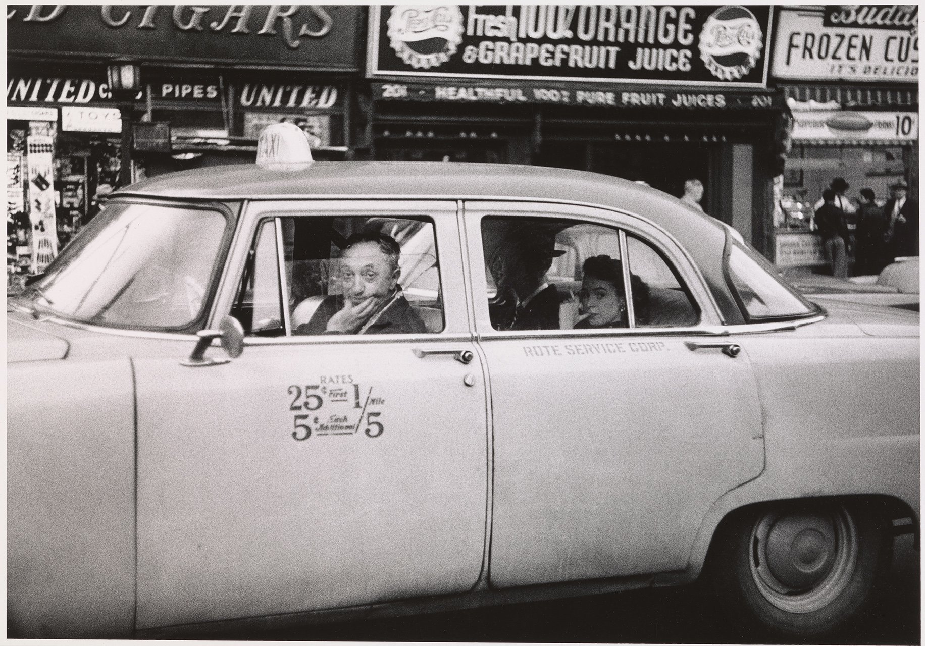 Diane Arbus, <em>Taxicab driver at the wheel with two passengers, N.Y.C.</em> (1956). Courtesy of the Met Breuer, © The Estate of Diane Arbus, LLC. All Rights Reserved.