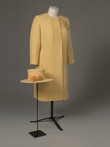 Queen Elizabeth II's Angela Kelly-designed crepe-wool beaded primrose dress and coat with matching hat adorned with handmade silk roses and apricot-colored leaves work for the wedding of His Royal Highness Prince William of Wales and Miss Catherine Middleton at Westminster Abbey on 29 April 2011. Courtesy of the Royal Collection Trust.