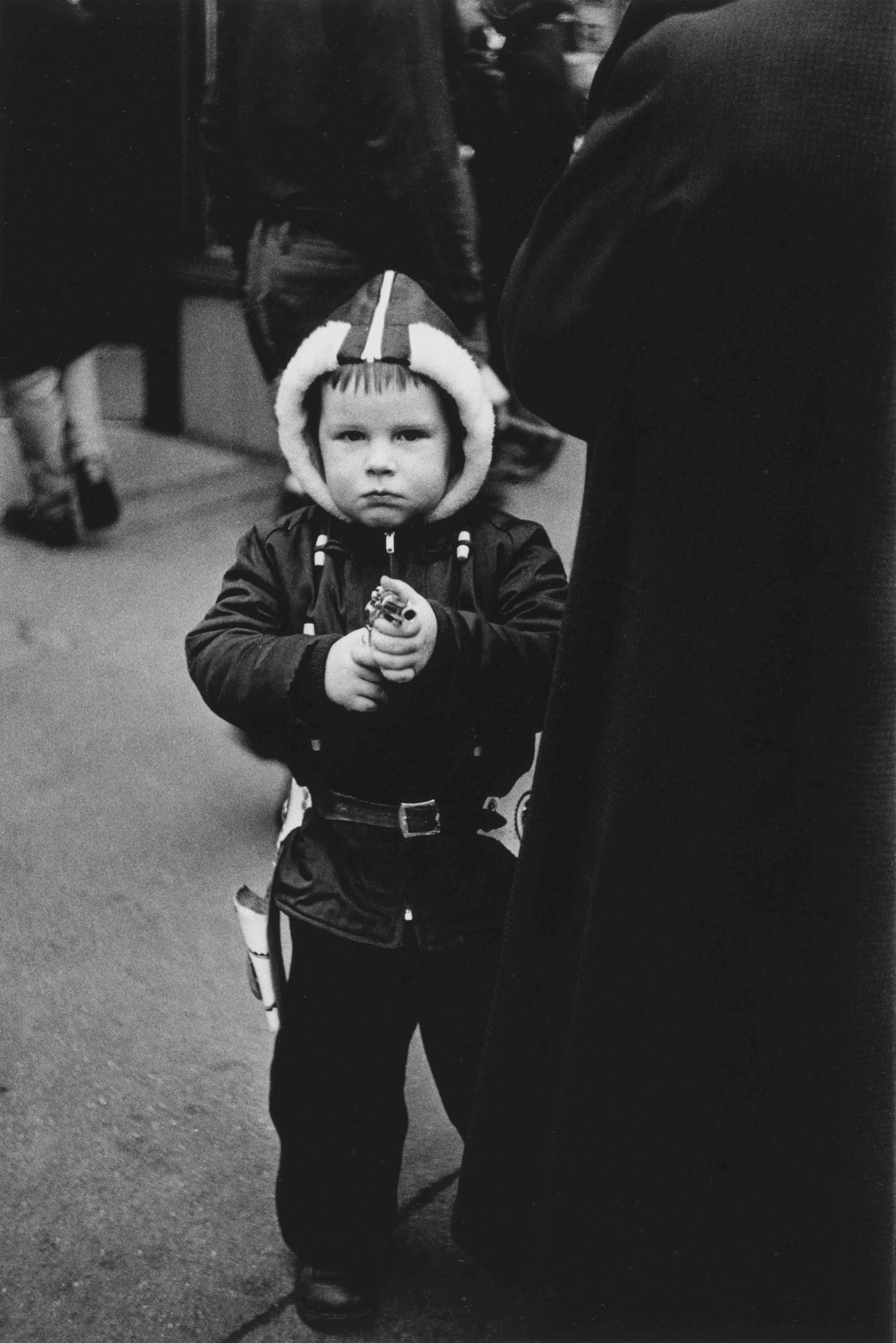 Diane Arbus. Kid in a hooded jacket aiming a gun, N.Y.C. 1957.