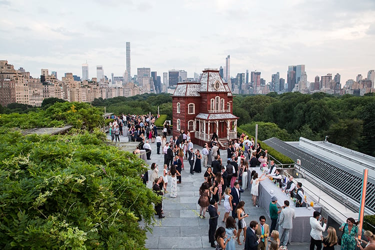 Guests on the roof with Cornelia Parker's Transitional Object (PsychoBarn) at the Met: Young Members Party 2016. Courtesy of Sam Deitch/BFA.