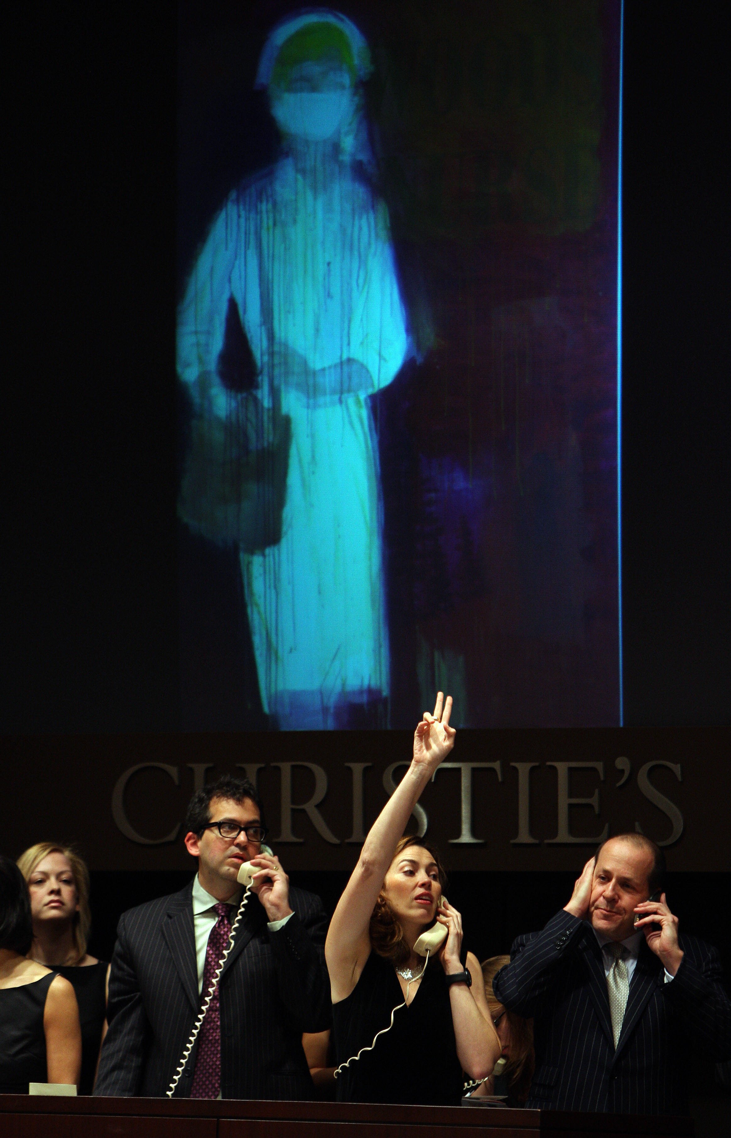 Christie's auction house staff place bids received over the phone for "Piney Woods Nurse" by artist Richard Prince during Christie's bi-annual Post-War and Contemporary Art Sale in New York, 13 November 2007. A phone bidder paid 5.4 million USD prior premium, while the work had been estimated to sell for 1.8-2.2 million USD. Christie's sale reached a total of 325 million USD from an estimate of 242 to 338 million USD. Courtesy of EMMANUEL DUNAND/AFP/Getty Images.