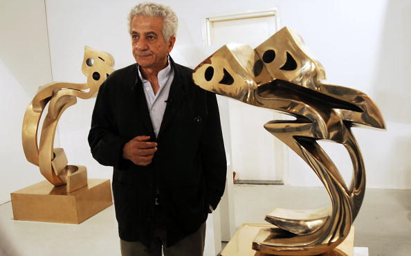 Parviz Tanavoli standing in an exhibition of his sculptures in Dubai, 2009. Courtesy of Haider Shah/AFP/Getty Images