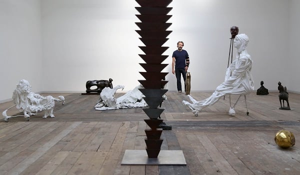 Artist Mike Nelson with sculptural works which form part of the V-A-C collection that Nelson has selected for the exhibition at the Whitechapel Gallery in London, 2014. Courtesy of Geoff Caddick/PA