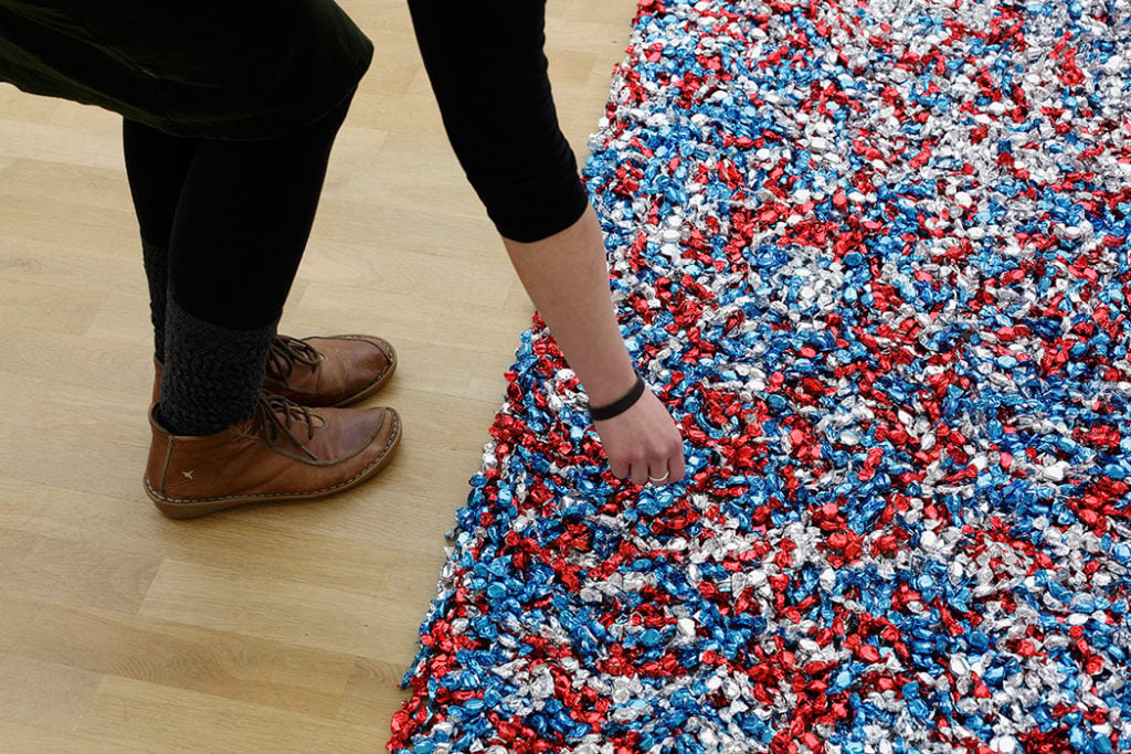 Felix Gonzalez-Torres, "Untitled" (USA Today), 1990. Candies individually wrapped in red, silver, and blue cellophane, endless supply. Installation view of Felix Gonzalez-Torres: Specific Objects without Specific Form, Museum Für Moderne Kunst, Frankfurt, Germany, January 28 - March 14, 2011. © The Felix Gonzalez-Torres Foundation, courtesy of Andrea Rosen Gallery, New York