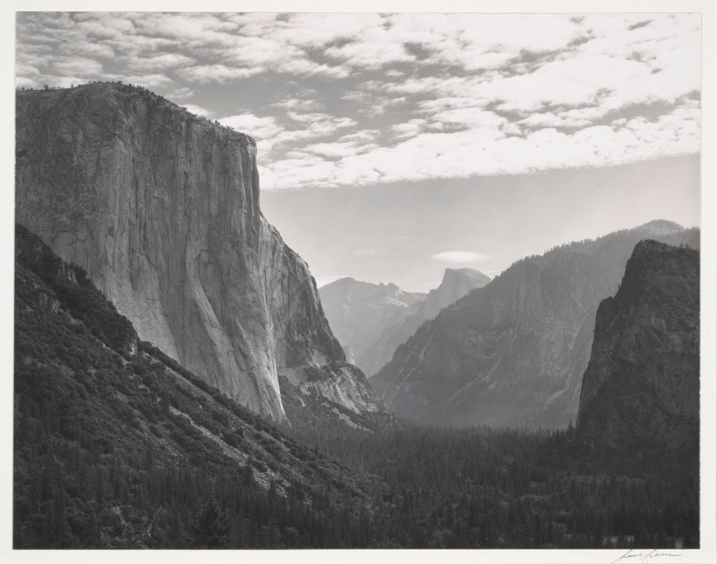 [dark valley view without waterfall, Half Dome in center distance with pale lcloud above it, layer of pale mackerel clouds above] Do not crop, alter photograph. ALL RIGHTS RESERVED. All scans provided by the Center are solely and specifically for one-time, single use reproduction as noted on CCP Invoice and related documents. NOTE: The Center RETAINS COPYRIGHT on ALL digital reproduction FILES with embedded metadata provided from the Center's Collections (and ANY related derivatives which may be generated by client.) Scans of photographs provided by the Center for the above-detailed one-time reproduction purpose may not be digitally archived by the client, publisher, any subcontractor and/or agent who may be working on this project. All original and derivative digital copies of image files provided must be deleted from all digital storage media once the publication layout itself has been designed and archived.