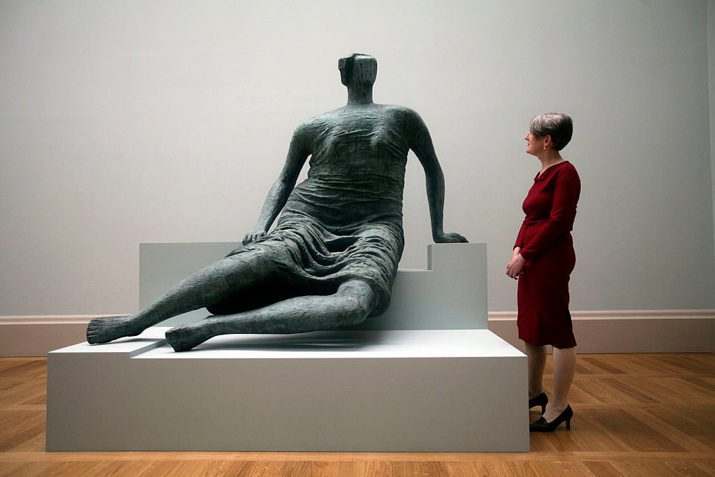 Penelope Curtis at Tate Britain next to Henry Moore's Draped Seated Figure. Photo by Warrick Page/Getty Images.