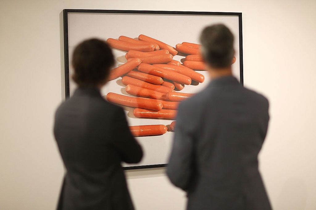 People look on at a piece by artist Lucas Blalock on display during the opening day of Art Basel on December 2, 2015 in Miami Beach, Florida. Courtesy of Joe Raedle/Getty Images.