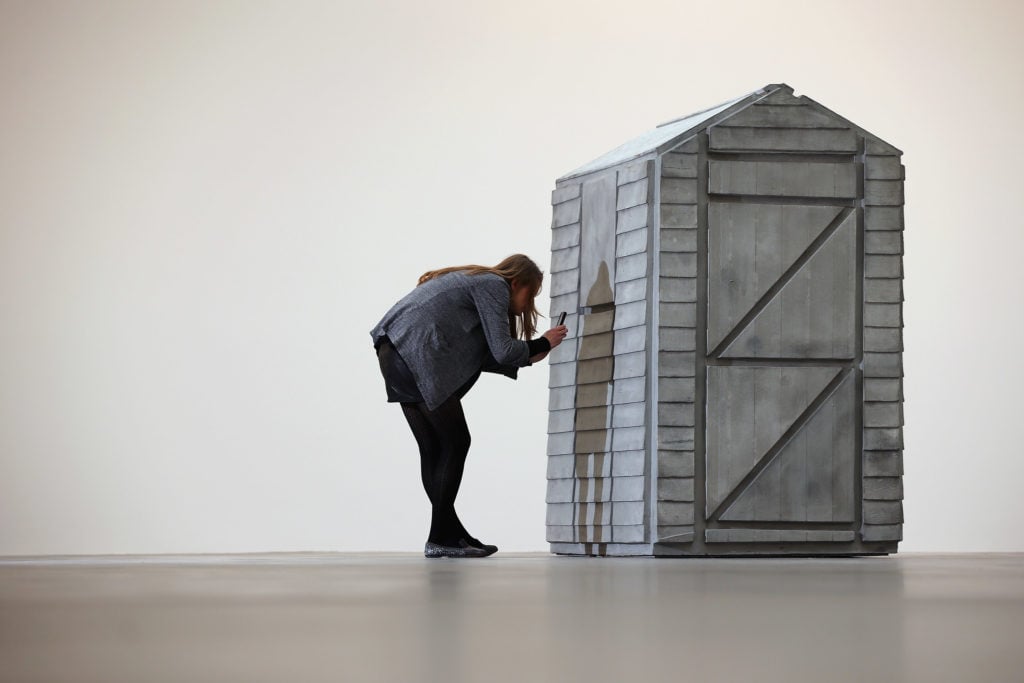 A visitor takes a photograph of a piece of work from Turner Prize winning British artist Rachel Whiteread's show, 