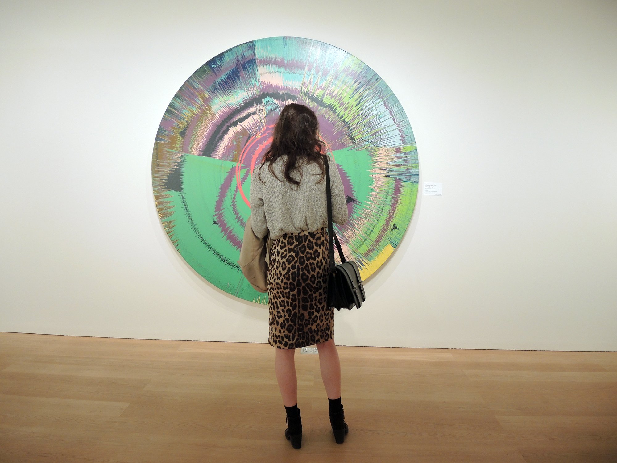 A woman looks at David Bowie and Damien Hirst's spin paintingBeautiful, hello, space-boy painting (1995). Courtesy of Sarah Cascone.