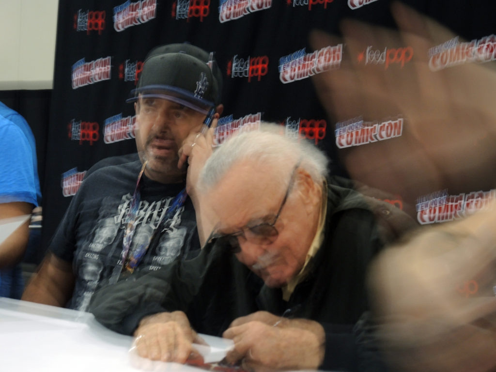 Stan Lee signs autographs at New York Comic Con 2016 as his handlers attempt to prevent artnet News from taking the comic legend's photo. Courtesy of Sarah Cascone.