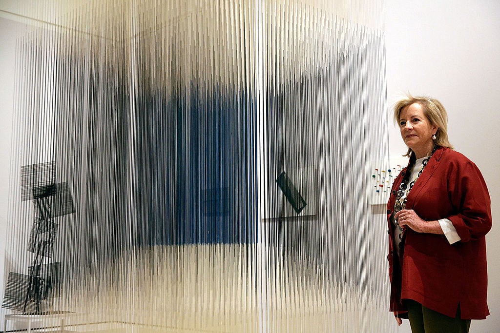 Patricia Phelps de Cisneros poses with the artwork 'Nylon Cube' by Venezuelan artist Jesus Soto, part of the exhibition Radical Geometry: Modern Art of South America from the Patricia Phelps de Cisneros Collection at the Royal Academy of Arts on July 1, 2014 in London, England. Photo by Matthew Lloyd/Getty Images.