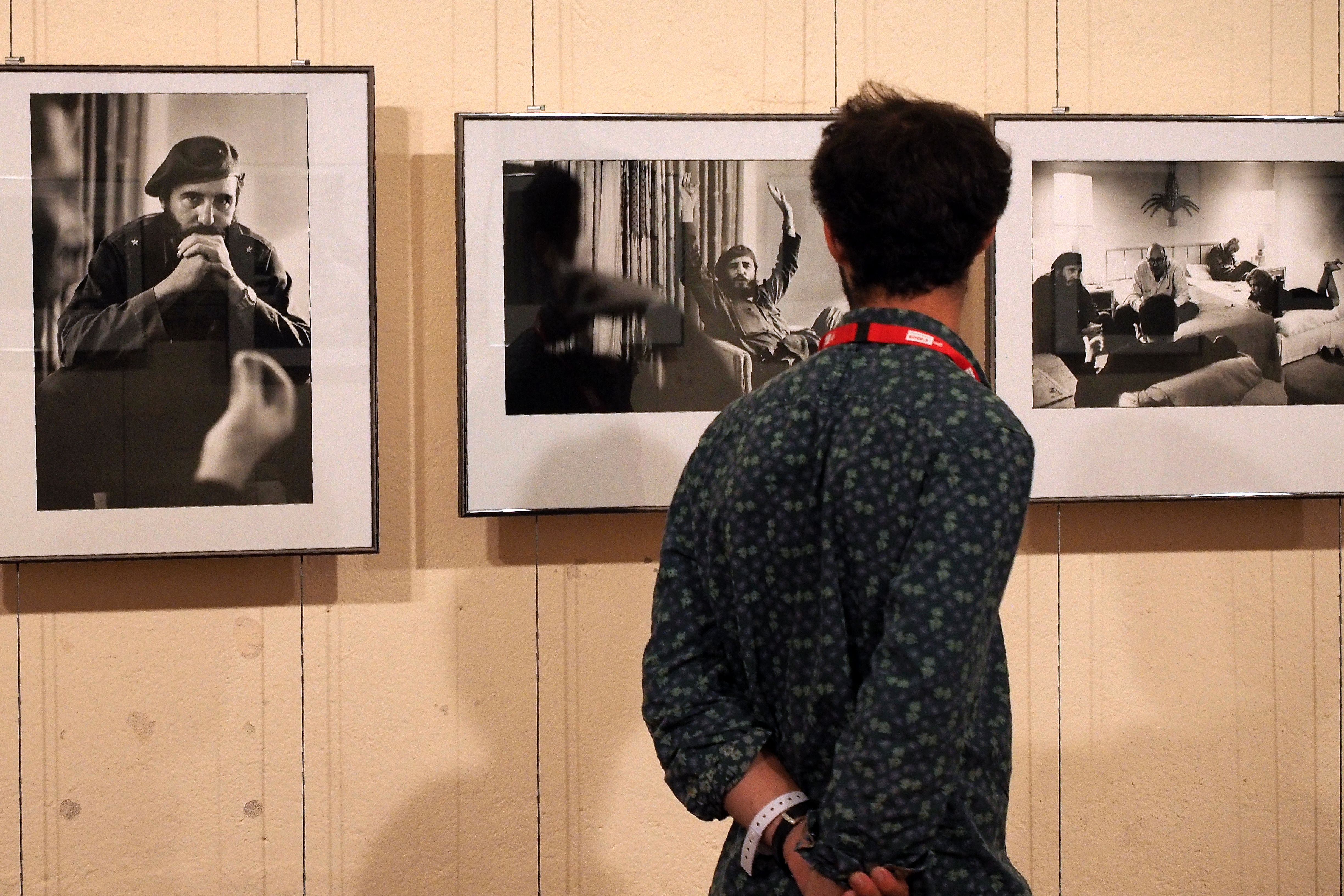 A visitor looks at photographies of the exhibition "Cuba" by French photographer and reporter Marc Riboud, on August 31, 2016, during the 28th Visa pour l'Image international festival of photojournalism in Perpignan, southern France. Photo: RAYMOND ROIG/AFP/Getty Images.
