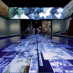 Video screens and an interactive table are part of the Making a Way Out of No Way exhibit on the third floor Community Galleries. Courtesy of Getty Images.