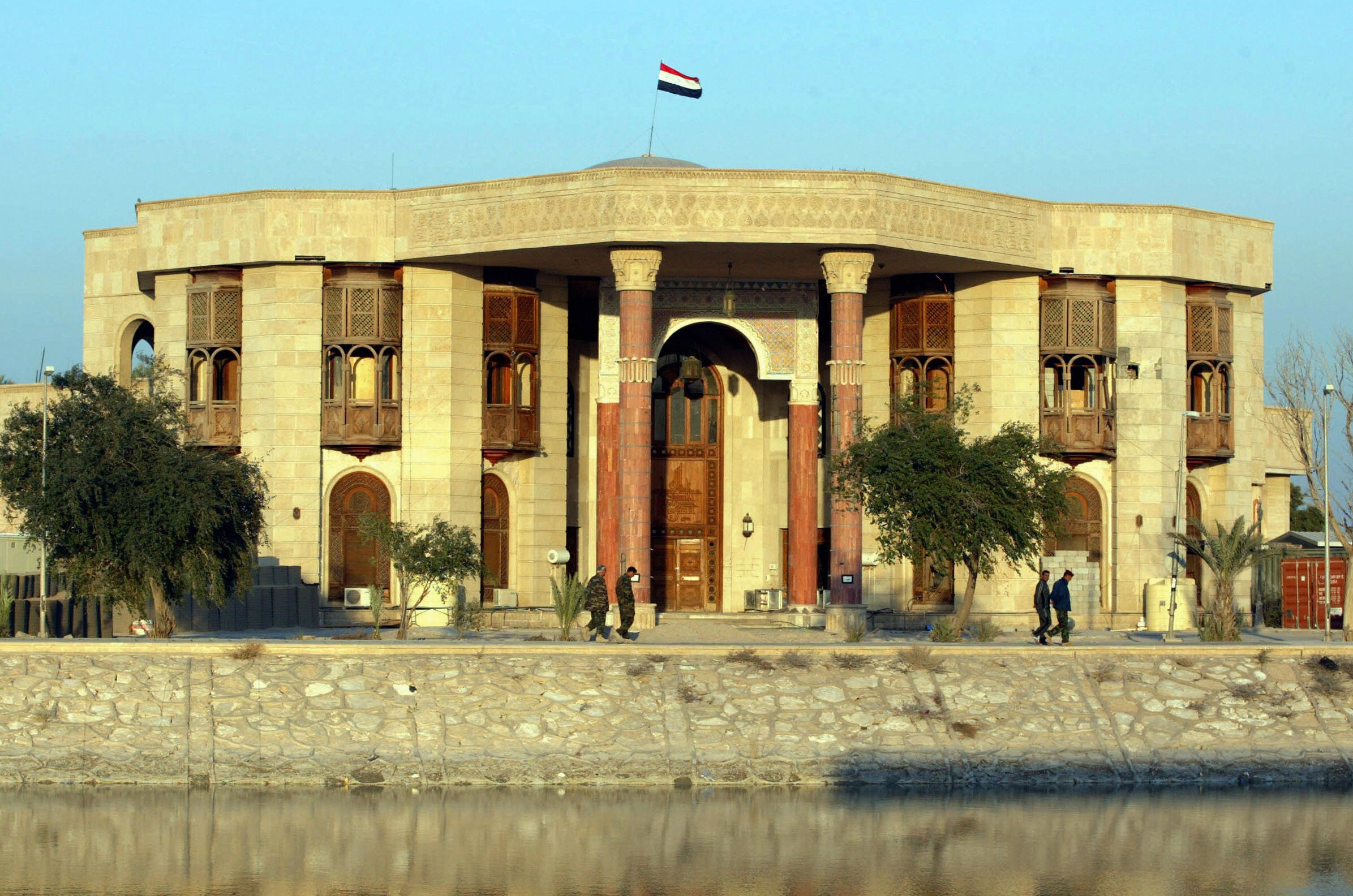 Iraqi soldiers walk outside the Basra palaces, once home to Saddam Hussein, in 2008. The building is now a museum. Courtesy of Essam Al-Sudani/AFP/Getty Images.