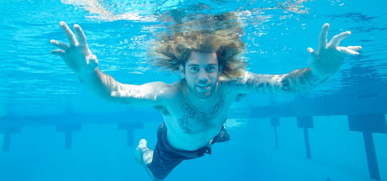 Spencer Elden recreates his pose from the cover of Nirvana's album Nevermind, shot when he was a baby, 25 years later. Courtesy of John Chapple.