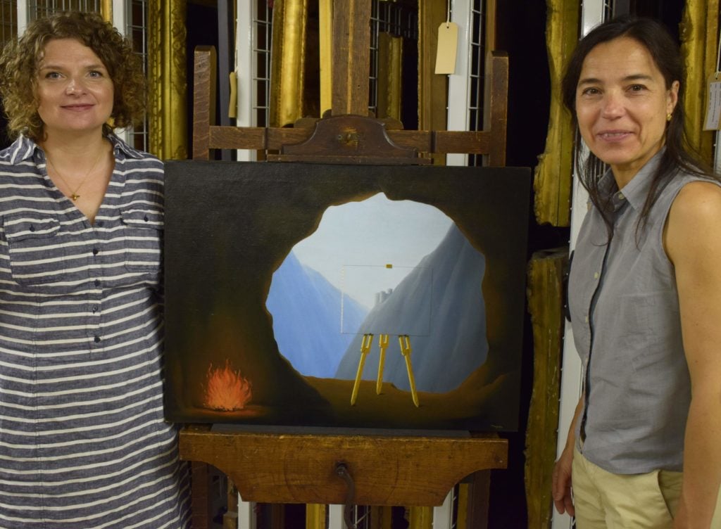 Curator of Historic Art at Norwich Castle, Giorgia Bottinelli (left) and conservator Alice Tavares da Silva with Magritte’s La Condition Humaine (1935). © Norfolk Museums Service.