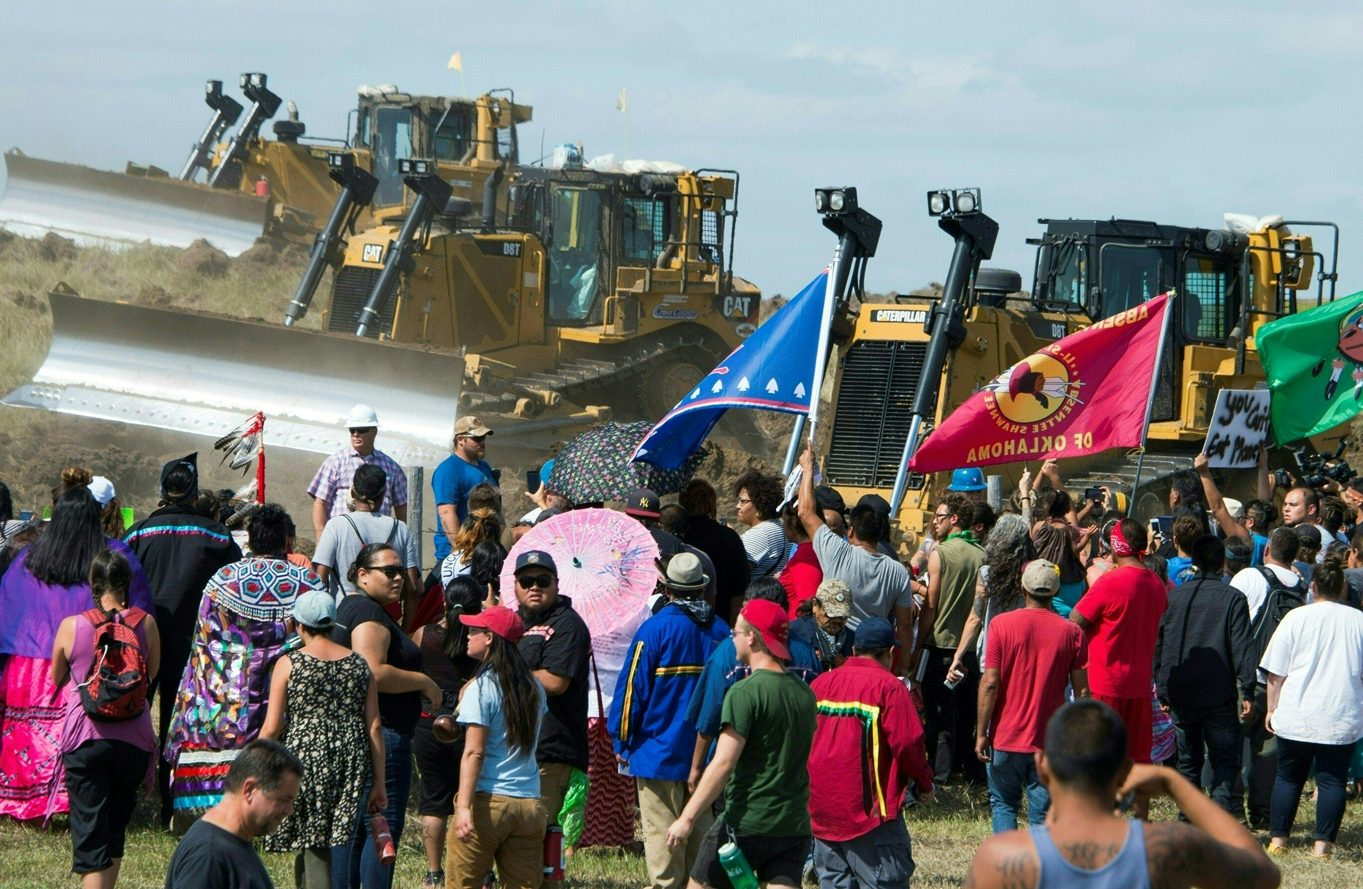 Members of the Standing Rock Sioux Tribe and their supporters opposed to the Dakota Access Pipeline (DAPL) confront bulldozers working on the new oil pipeline in an effort to make them stop, September 3, 2016, near Cannon Ball, North Dakota. / AFP / Robyn BECK / TO GO WITH AFP STORY by Nova SAFO, "Native Americans united by oil pipeline fight. Photo Robyn Beck/AFP/Getty Images.