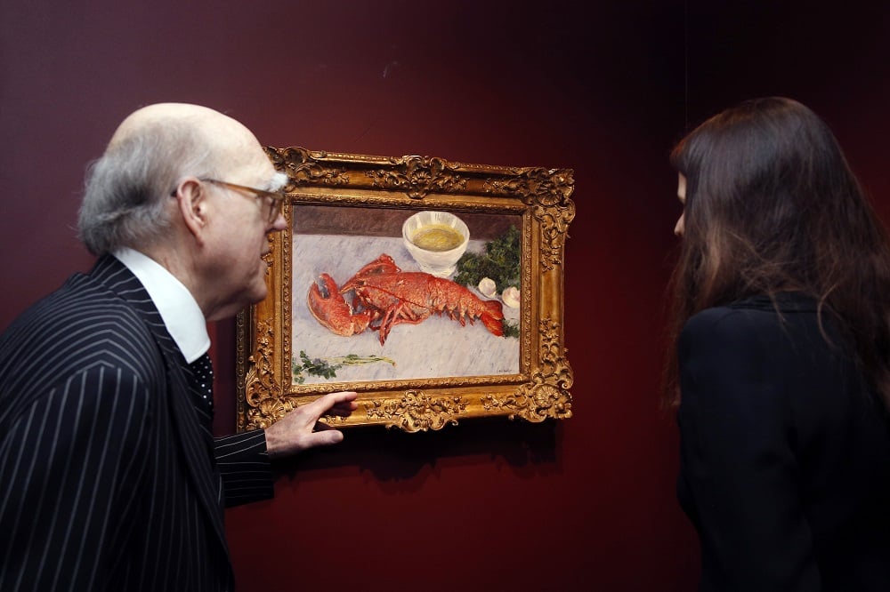 Spencer Hays presents Gustave Caillebotte's Nature morte au Homard at the Orsay Museum in Paris. Photo courtesy Francois Guillot/AFP/Getty Images.