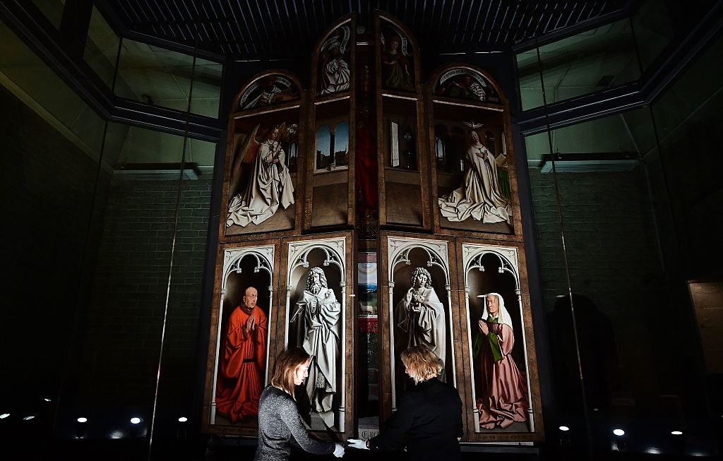 Officials unveil the restored exterior panels of "The Adoration of the Mystic Lamb." Photo courtesy EMMANUEL DUNAND/AFP/Getty Images.
