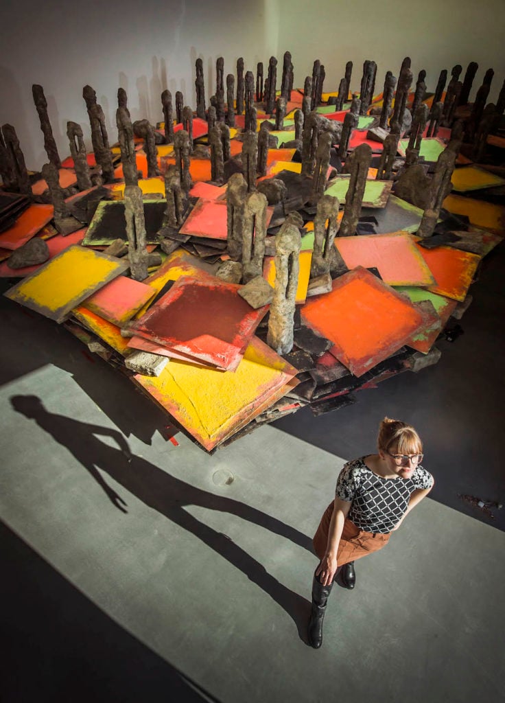 Visitor takes first look at 'Screestage' (2013) by Phyllida Barlow, part of the inaugural Hepworth Prize for Sculpture. Photo courtesy: Danny Lawson/PA Wire.