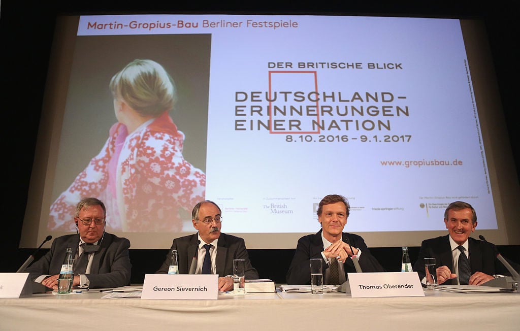 (Left to Right) Barrie Cook, curator of the exhibition; Gereon Sievernich, director of the Martin Gropius Bau; Thomas Oberender, director of the Berliner Festspiele; and British art historian Neil MacGregor at a press conference prior to the opening of “The British View: German - Memories of a Nation” exhibition at the Martin Gropius Bau in Berlin on October 7, 2016. Photo Adam Berry/AFP/Getty Images.