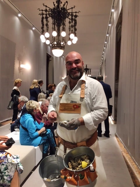 An oyster shucker waits on guests at the VIP preview of TEFAF New York. Photo by Eileen Kinsella