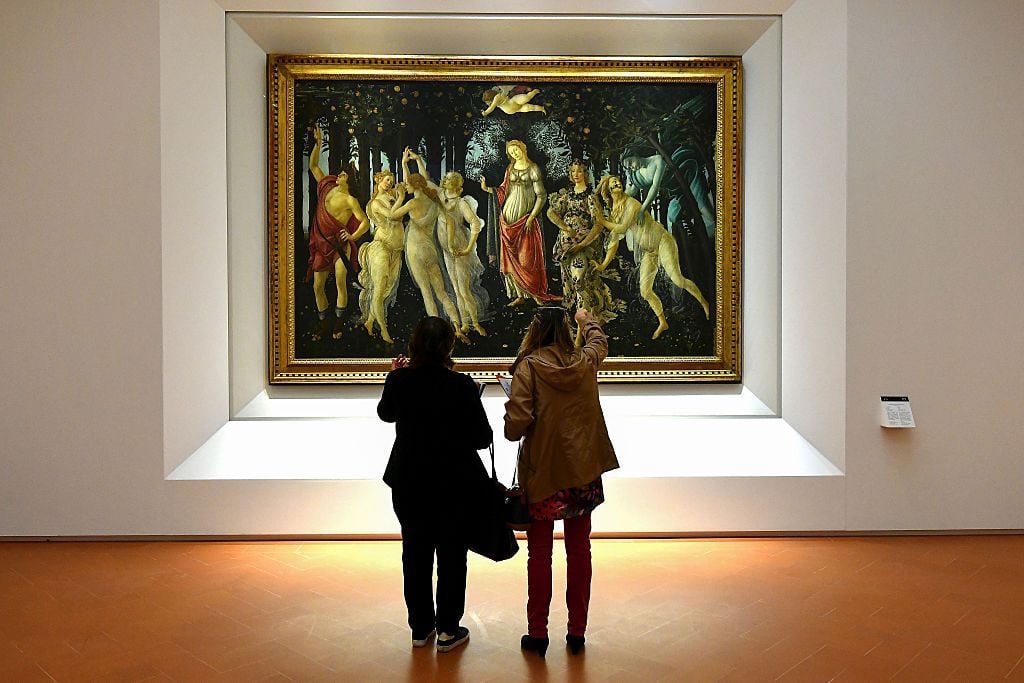 People look at Sandro Botticelli’s Spring (1482) during a press preview for the reopening the rooms dedicated to Pollaiolo and Botticelli, at the Uffizi Gallery in Florence, on October 17, 2016. Photo Alberto Pizzoli/AFP/Getty Images.