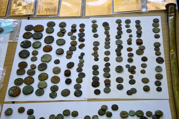 Dozens of illegally-excavated ancient coins seized from a large smuggling gang. Image courtesy Greek Police via AP.