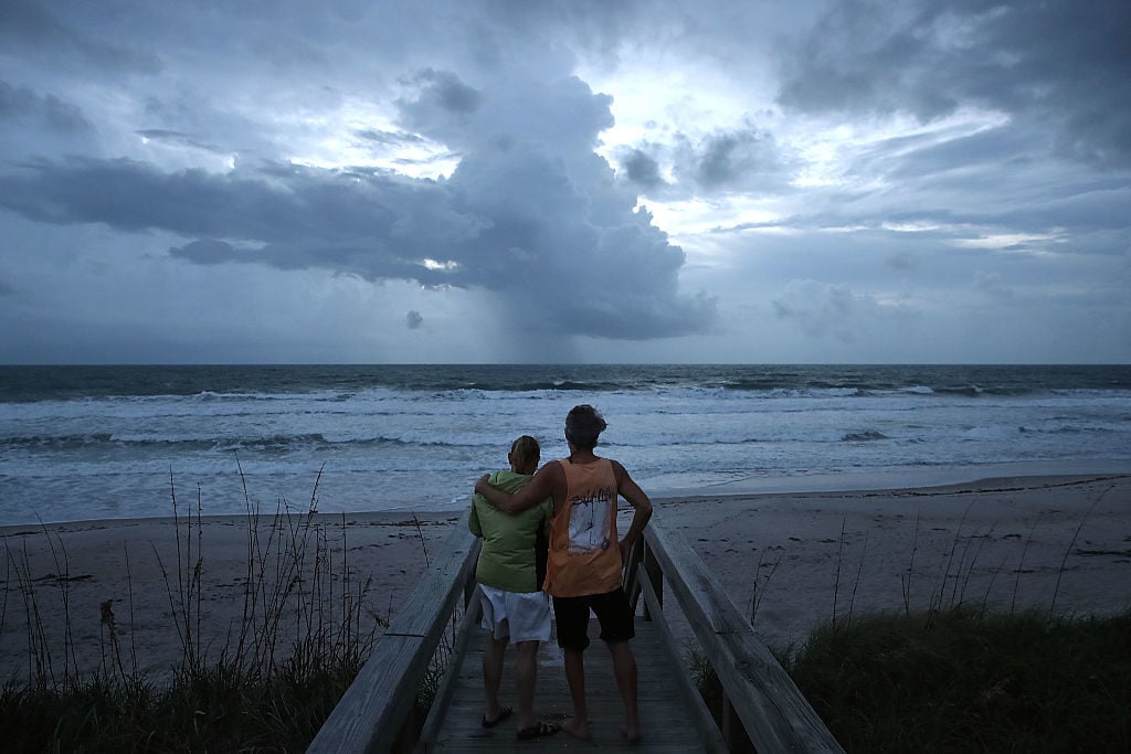 Rod Smith hugs his wife Karen as they watch the churning surf on October 6, 2016 on Satellite Beach, Florida. Hurricane Matthew is expected to reach the area later this afternoon. Photo Mark Wilson/Getty Images.