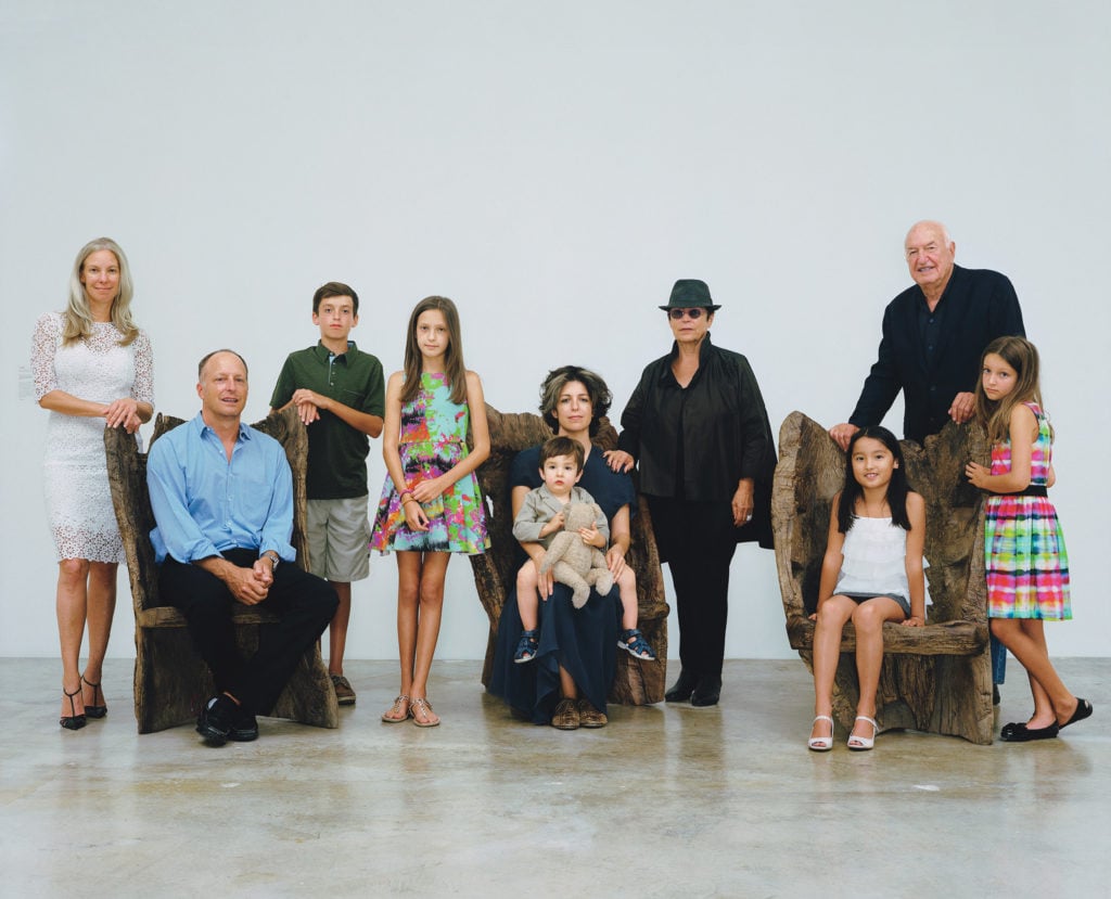 The Rubell Family at the Rubell Family Collection in Miami, on chairs by the Chinese artist He Xiangyu, from left: Michelle, Jason, Samuel, Ella, Jennifer, Max Wyss Rubell (on lap), Mera, Stevie Kim-Rubell, Don, and Olivia. Sittings editor: Photo by Rineke Dijkstra.