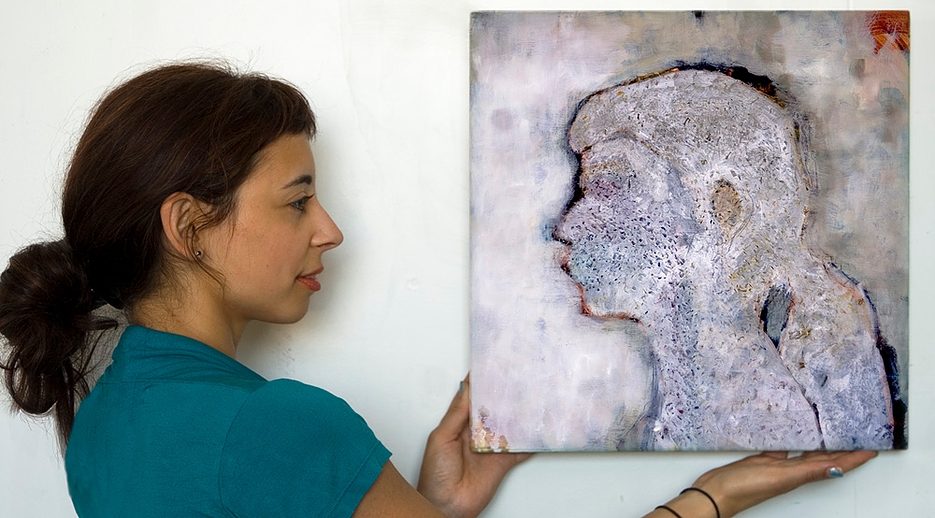  Joana Ricou holding <em>Our Self Portrait: The Human Microbiome</em>. Courtesy of Joana Ricou. 