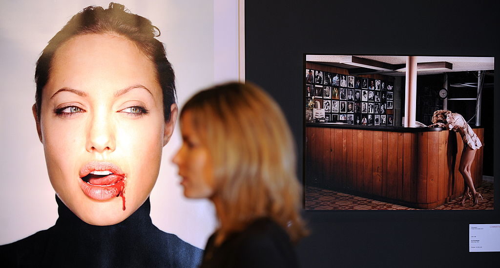Photographic prints entitled "Angelina with Blood" (L) by Martin Schoeller and "Movie Star" (R) by David Drebin are pictured during a press preview ahead of the 'Photographs' auction at Christie's auction house in London, on November 22, 2010. Courtesy of ADRIAN DENNIS/AFP/Getty Images.