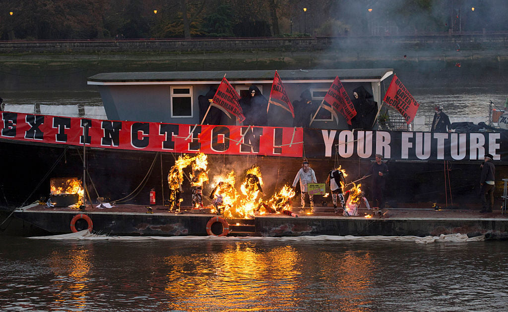 Joe Corré's punk memorabilia collection on fire on a boat in London. Photo by John Phillips, courtesy Getty Images.