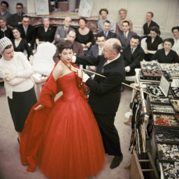 Christian Dior with fashion model Victoire wearing the "Zaire" dress (Autumn-Winter Haute Couture collection, H line), 1954. Courtesy of National Gallery of Victoria, © Mark Shaw.
