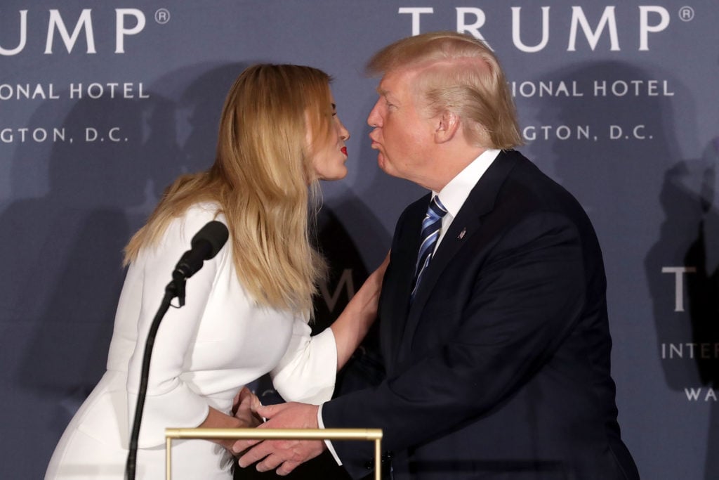 Republican presidential nominee Donald Trump and his daughter Ivanka Trump kiss after speaking during the grand opening of the new Trump International Hotel October 26, 2016 in Washington, DC. Courtesy of Chip Somodevilla/Getty Images.