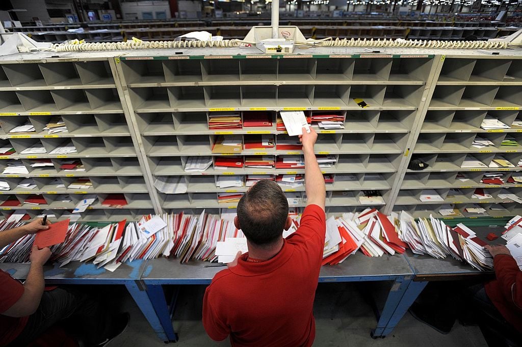 Staff members sort mail at the Royal Mail Distribution centre in Glasgow in what is traditionally the busiest day of the year for mail in the run up to Christmas on December 15, 2016. Photo Andy Buchanan/AFP/Getty Images.