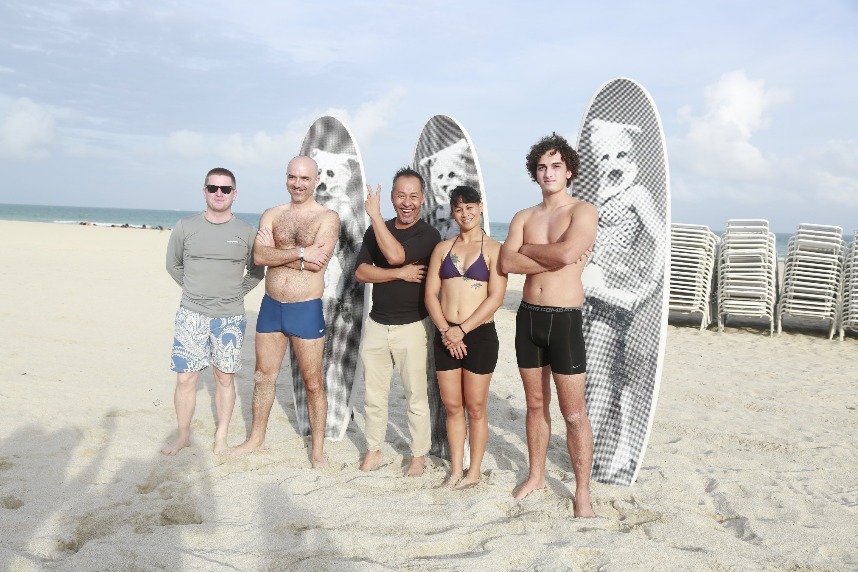 Tomas Vu, center, with the author and a few surfers on the beach at the Untitled art fair.