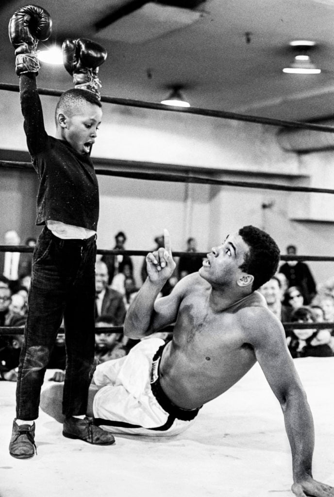George Kalinsky, Muhammad Ali training at Madison Square Garden (1967). Courtesy George Kalinsky. Ali, who had a soft spot for children, took a break from a workout to banter with a young fan. Kalinsky recalled this young admirer announcing, “I am the greatest for a moment.”