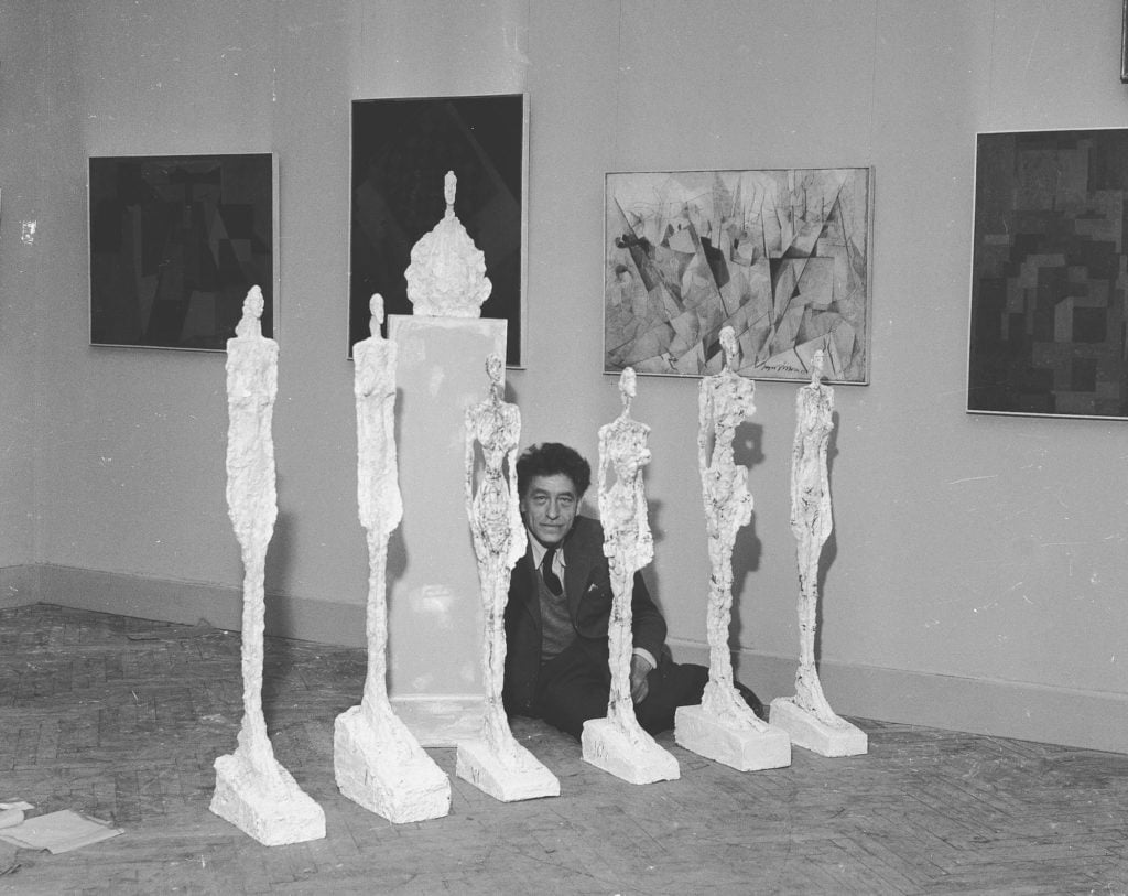 Alberto Giacometti and his sculptures at the 1956 Venice Biennale. Courtesy of the Giacometti Foundation.